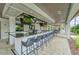 Outdoor bar area with marble countertop, TV, and comfortable seating at 16927 April Plush Dr, Wimauma, FL 33598