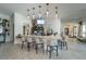 Modern bar area with marble countertop, bar seating, stylish pendant lights and television screen at 16927 April Plush Dr, Wimauma, FL 33598