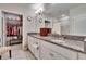 Bright bathroom with granite countertops and dual sinks; also features a large walk-in shower at 16927 April Plush Dr, Wimauma, FL 33598