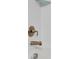 Bathtub fixtures are brushed bronze with matching accessories, set against white tiled walls at 16927 April Plush Dr, Wimauma, FL 33598