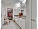 Bright bathroom with granite countertops, dual sinks, large mirror and access to a spacious walk-in closet at 16927 April Plush Dr, Wimauma, FL 33598