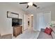 A secondary bedroom with a closet, a ceiling fan, and a view of the hallway at 16927 April Plush Dr, Wimauma, FL 33598