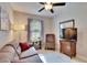 A cozy secondary bedroom with a ceiling fan and comfortable seating at 16927 April Plush Dr, Wimauma, FL 33598