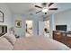 Bedroom with en-suite bathroom and partial view into the living room at 16927 April Plush Dr, Wimauma, FL 33598