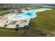 Aerial shot of lagoon with beach, and sand. The edge is fenced with green space on the opposite side at 16927 April Plush Dr, Wimauma, FL 33598