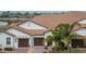 A beautiful exterior view of a well-maintained home with a tile roof and three-car garage at 16927 April Plush Dr, Wimauma, FL 33598