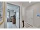 Hallway leading to the secondary bedroom and featuring a smart home control panel at 16927 April Plush Dr, Wimauma, FL 33598