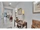Hallway featuring a console table with decorative lamps and a framed mirror at 16927 April Plush Dr, Wimauma, FL 33598