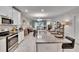 Open floor plan with a view from the kitchen island through the dining area to the living room at 16927 April Plush Dr, Wimauma, FL 33598