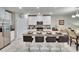 Open kitchen featuring a granite island with seating, stainless appliances, and white cabinetry at 16927 April Plush Dr, Wimauma, FL 33598