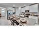 Eat-in kitchen island boasts granite countertops, stainless sink, and seating for four at 16927 April Plush Dr, Wimauma, FL 33598