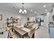Open concept with kitchen island, stainless appliances, seamlessly connected to the dining space at 16927 April Plush Dr, Wimauma, FL 33598