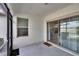 Screened lanai with sliding glass doors and a window looking out to the backyard and palms at 16927 April Plush Dr, Wimauma, FL 33598