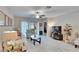 Inviting living room with tile flooring, neutral colors, and sliding glass doors to the outside patio at 16927 April Plush Dr, Wimauma, FL 33598