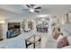 Open-concept living room flows into the dining area and kitchen featuring modern lighting and neutral tones at 16927 April Plush Dr, Wimauma, FL 33598