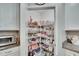 Walk-in pantry with wire shelves, providing ample storage space for food and kitchen essentials at 16927 April Plush Dr, Wimauma, FL 33598