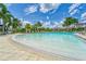 Zero-entry pool with palm trees, comfortable seating, and ample sunshine at 16927 April Plush Dr, Wimauma, FL 33598