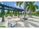 Relaxing poolside lounge area with shade pergolas and comfortable seating at 16927 April Plush Dr, Wimauma, FL 33598