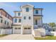 Modern white two-story home featuring a dual-car garage and elevated entry with sleek architectural details at 1745 Massachusetts Ne Ave, St Petersburg, FL 33703