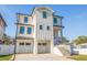 Modern white two-story home featuring a dual-car garage and elevated entry with sleek architectural details at 1745 Massachusetts Ne Ave, St Petersburg, FL 33703