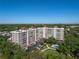 Aerial view of a multi-story condominium complex and the surrounding landscape and pool area at 2403 S Ardson Pl # 902B, Tampa, FL 33629