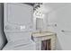 Bright bathroom featuring a stacked washer and dryer combo and a vanity with a stone countertop and ample storage at 2403 S Ardson Pl # 902B, Tampa, FL 33629