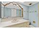Bathroom with white vanity, decorative mirror, and gold hardware and fixtures at 2403 S Ardson Pl # 902B, Tampa, FL 33629