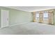 Large bedroom features bright windows with floral curtains and plush carpeting at 2403 S Ardson Pl # 902B, Tampa, FL 33629