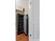 Walk in closet featuring white shelving, a gun safe and hardwood floors at 2403 S Ardson Pl # 902B, Tampa, FL 33629