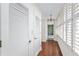 Hallway with hardwood floors, louvered doors, and ample storage at 2403 S Ardson Pl # 902B, Tampa, FL 33629