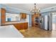 Bright kitchen features a stainless refrigerator, double oven, wood cabinets, and light blue walls at 2403 S Ardson Pl # 902B, Tampa, FL 33629