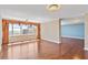 Open-concept living space with hardwood floors, large windows and an adjacent room at 2403 S Ardson Pl # 902B, Tampa, FL 33629