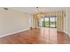 Living room with hardwood floors, chandelier, and sliding doors to a balcony with a view at 2403 S Ardson Pl # 902B, Tampa, FL 33629