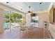 The pool house has a large dining table, seating, and a full kitchen setup near the pool area at 2403 S Ardson Pl # 902B, Tampa, FL 33629
