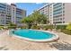 The community pool features lounge chairs and tables; perfect for unwinding or entertaining guests at 2403 S Ardson Pl # 902B, Tampa, FL 33629