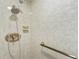 Tiled shower with updated shower head and bronze grab bar in a bathroom at 2403 S Ardson Pl # 902B, Tampa, FL 33629