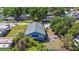 Aerial shot of a blue house featuring a gray roof, green backyard, and outdoor patio at 2408 Linsey St, Tampa, FL 33605