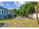 Expansive backyard with paver patio, fire pit, and lush greenery, perfect for outdoor entertaining at 2408 Linsey St, Tampa, FL 33605