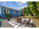 Cozy backyard with paver patio featuring outdoor seating and a charming blue house exterior at 2408 Linsey St, Tampa, FL 33605