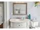 Bathroom vanity with marble countertop, decorative mirror, and stylish fixtures at 2408 Linsey St, Tampa, FL 33605