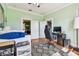 Bright bedroom or office featuring hardwood floors, a modern desk setup, and a comfortable atmosphere for work or relaxation at 2408 Linsey St, Tampa, FL 33605