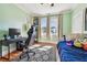 Bright bedroom with hardwood floors, desk, large windows, and a comfortable sleeping area at 2408 Linsey St, Tampa, FL 33605