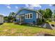 Charming blue house with a cozy porch and landscaped yard, creating inviting curb appeal at 2408 Linsey St, Tampa, FL 33605