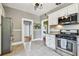 Well-appointed kitchen with stainless steel appliances, tiled floors, and neutral tones creating a clean and functional space at 2408 Linsey St, Tampa, FL 33605
