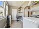 Functional laundry room with a washer, built-in shelving, and a compact workstation at 2408 Linsey St, Tampa, FL 33605