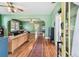 Inviting living room with hardwood floors, green walls, and an open doorway at 2408 Linsey St, Tampa, FL 33605