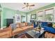 Bright living room with hardwood floors, couches, and green walls at 2408 Linsey St, Tampa, FL 33605
