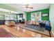 An open-concept living room featuring hardwood floors, large windows, and stylish furniture that provides a comfy space at 2408 Linsey St, Tampa, FL 33605