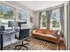 Office space featuring a modern desk, a leather sofa, and large windows with natural light at 2408 Linsey St, Tampa, FL 33605