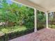 Secluded backyard with an abundance of trees, a well-manicured lawn and brick-paved patio at 2927 W Bayshore Ct, Tampa, FL 33611